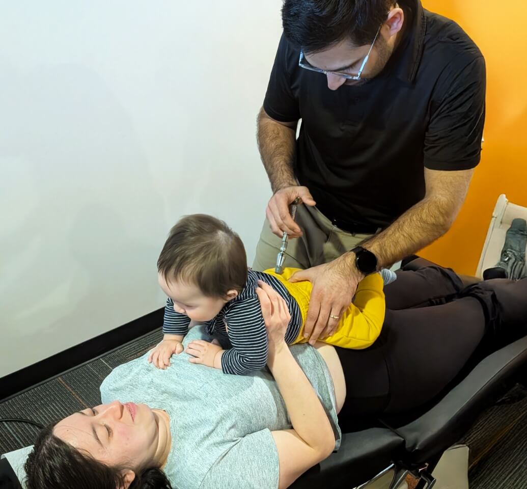 Pediatric Chiropractic patient getting adjusted with tool by Flowery Branch chiropractor Dr. Pranav