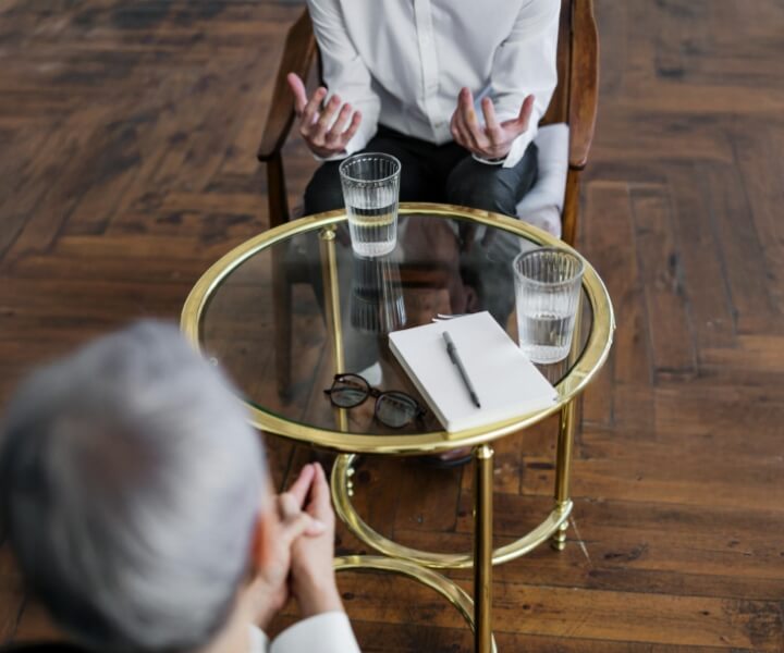 two people talking at table