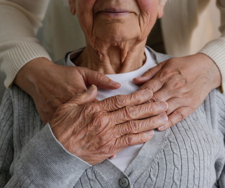 hands around senior patient