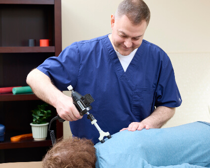 Dr. Tim using activator on spine