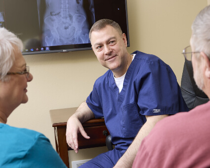 Dr. Tim consulting with patient