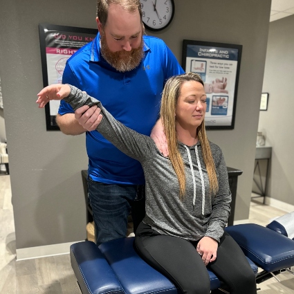 Synaptic Chiropractic patient having arm adjusted