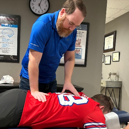 Synaptic Chiropractic patient having back adjusted