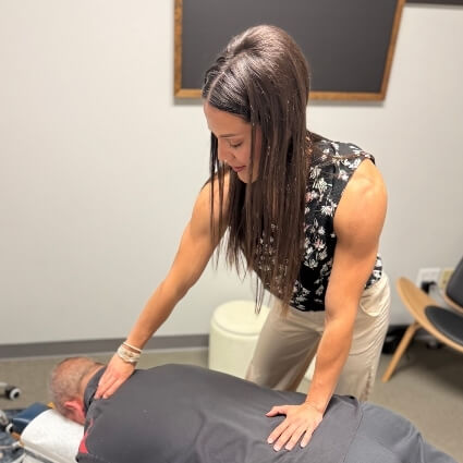 our chiropractor adjusting patients back