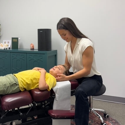 Dr Bland adjusting childs neck