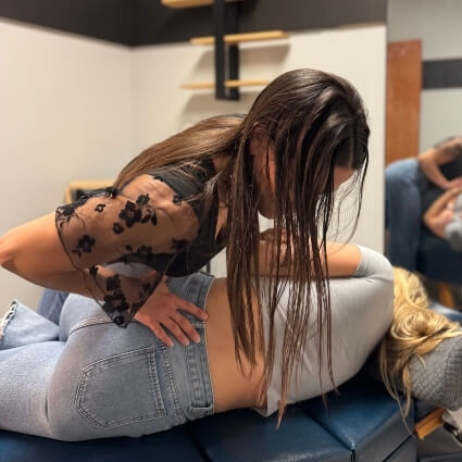 our chiropractor adjusting patients lower back