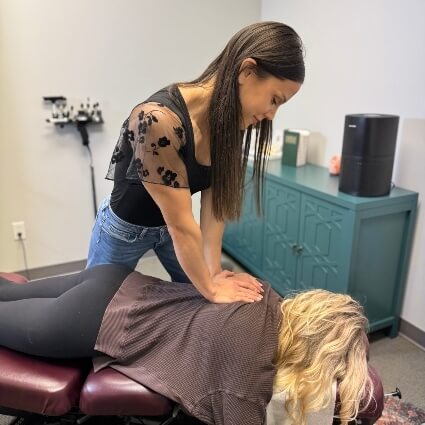 our chiropractor adjusting patients upper back