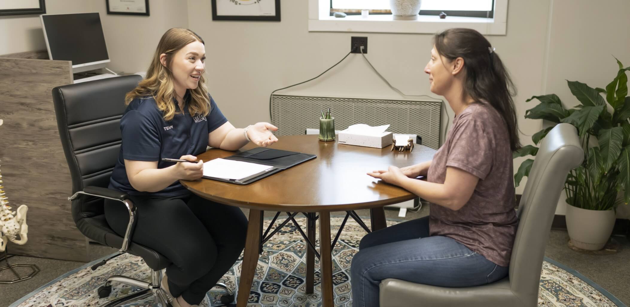 Keene chiropractor consulting with patient
