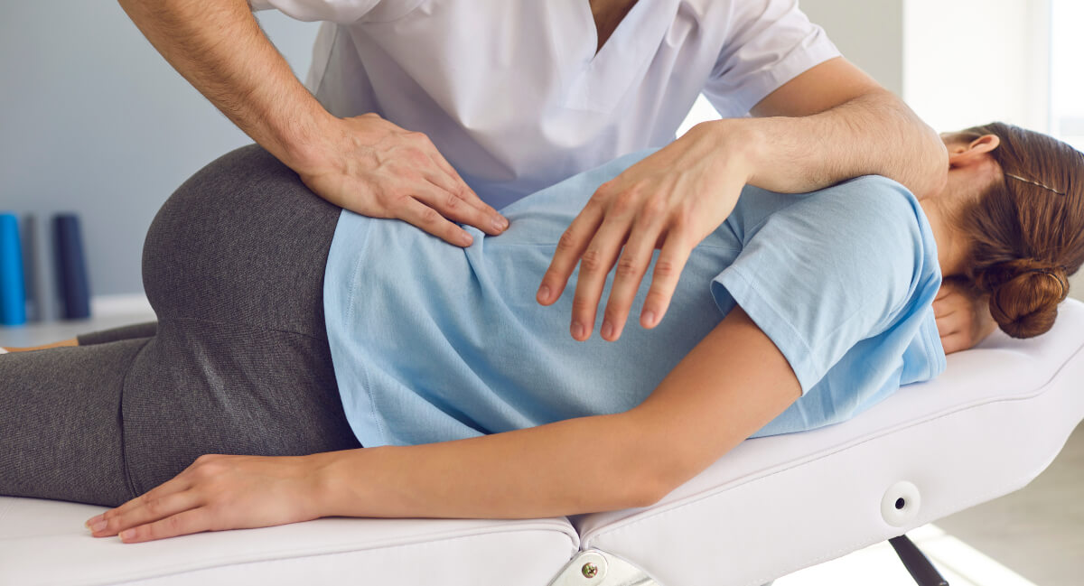 Female patient receiving a chiropractic adjustment