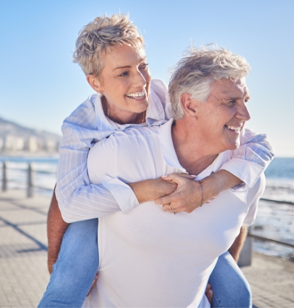 Man giving woman a piggy-back ride