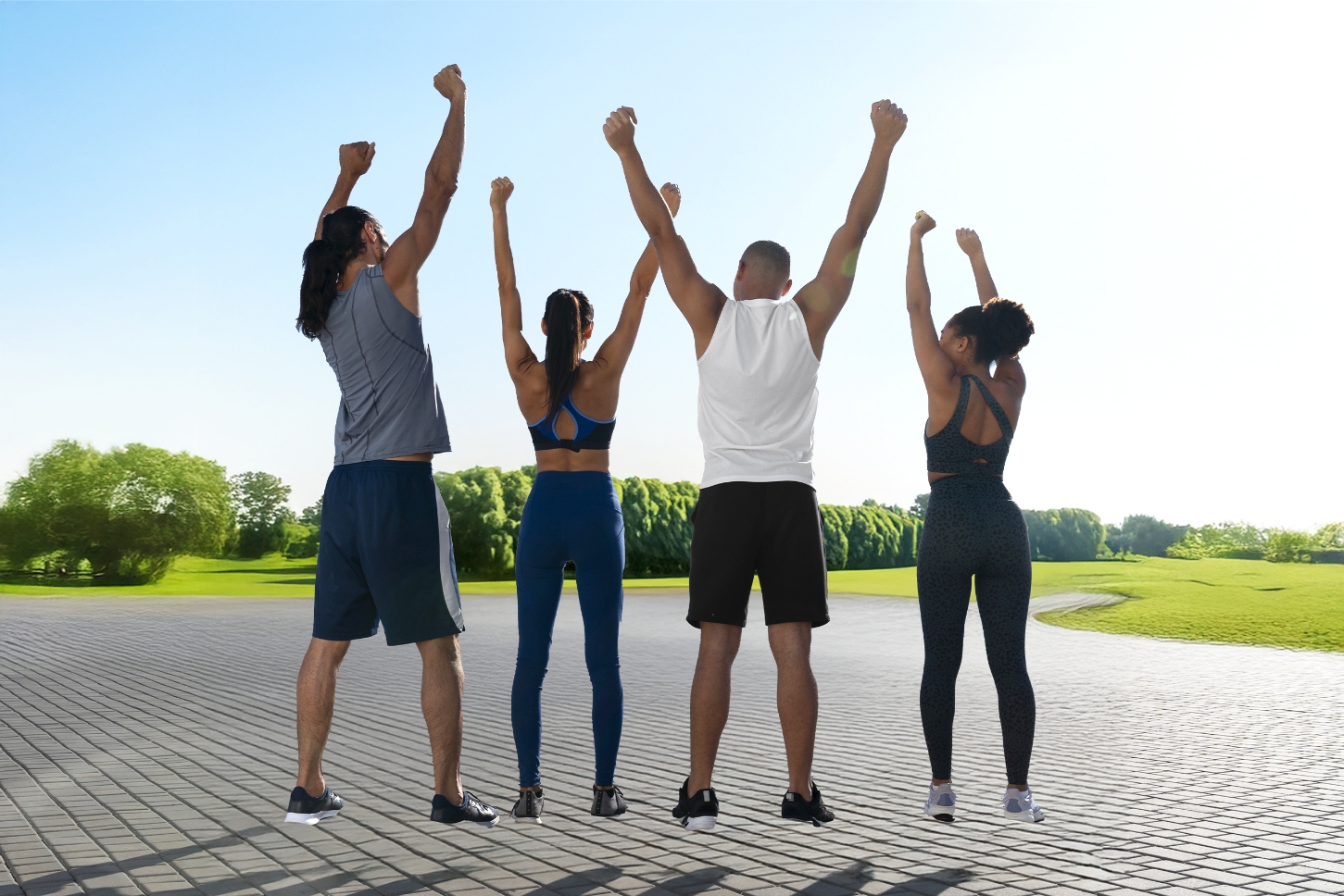Group of young adults raising their arms in the air