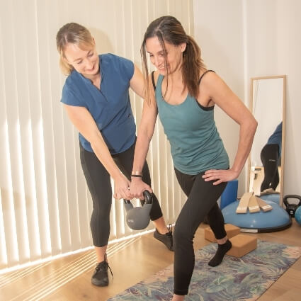Ali helping patient work out