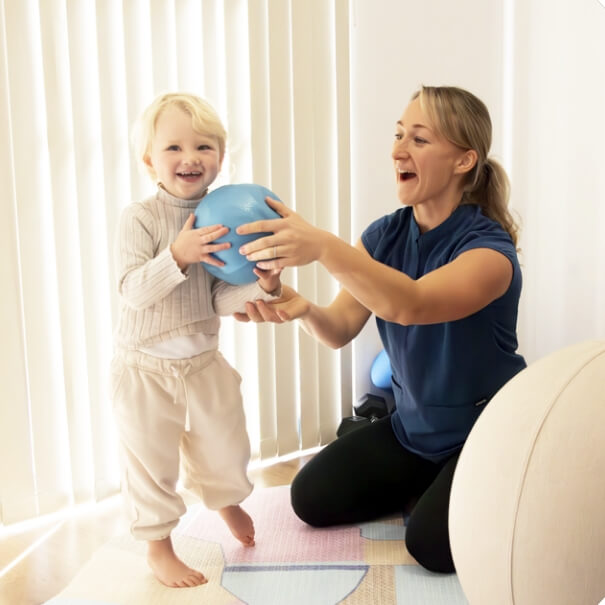 East Cannington practitioner with baby playing with a ball