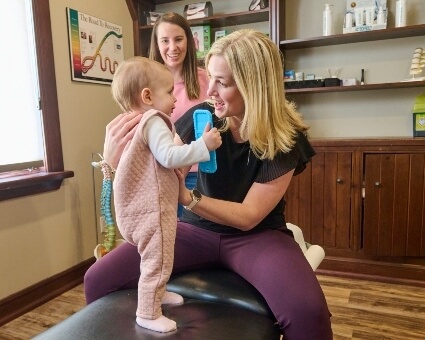 Chiropractor adjusting baby's neck