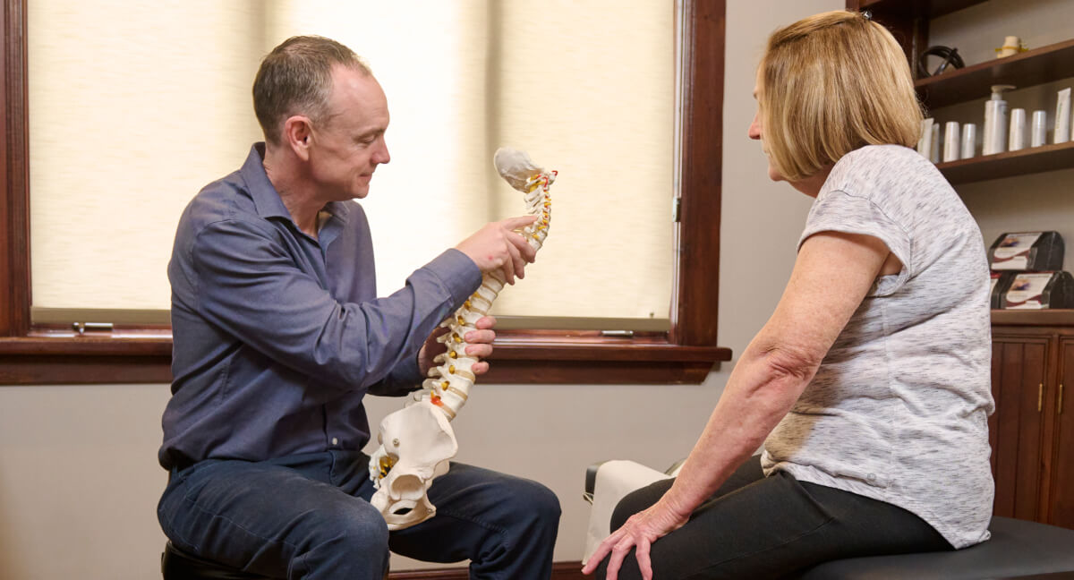 Dr. Scott discussing spine model with patient
