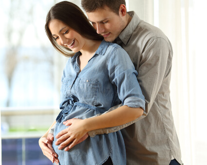 Smiling pregnant woman and husband