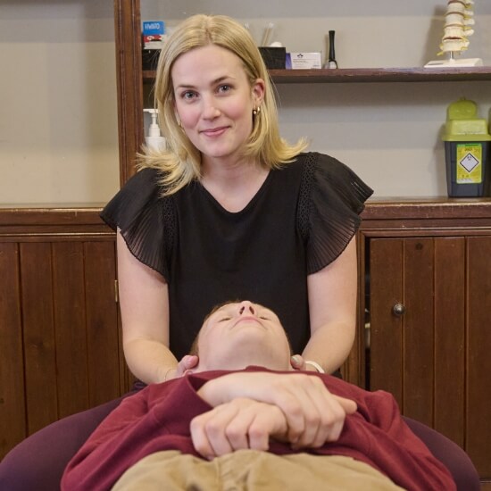 Caledon East chiropractor adjusting patient's neck