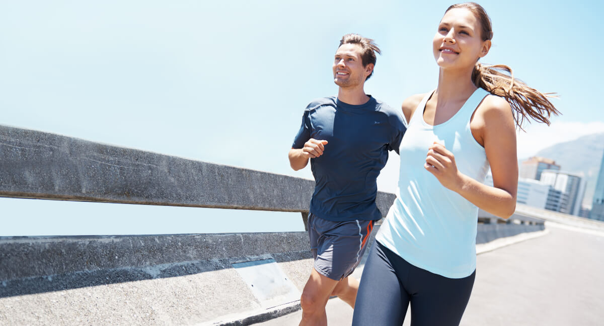 Smiling man and woman jogging