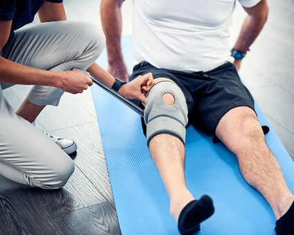 Man getting fitted for custom knee braces