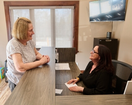 Receptionist talking to patient