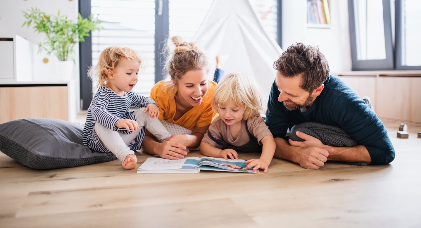 family of 4 reading books together