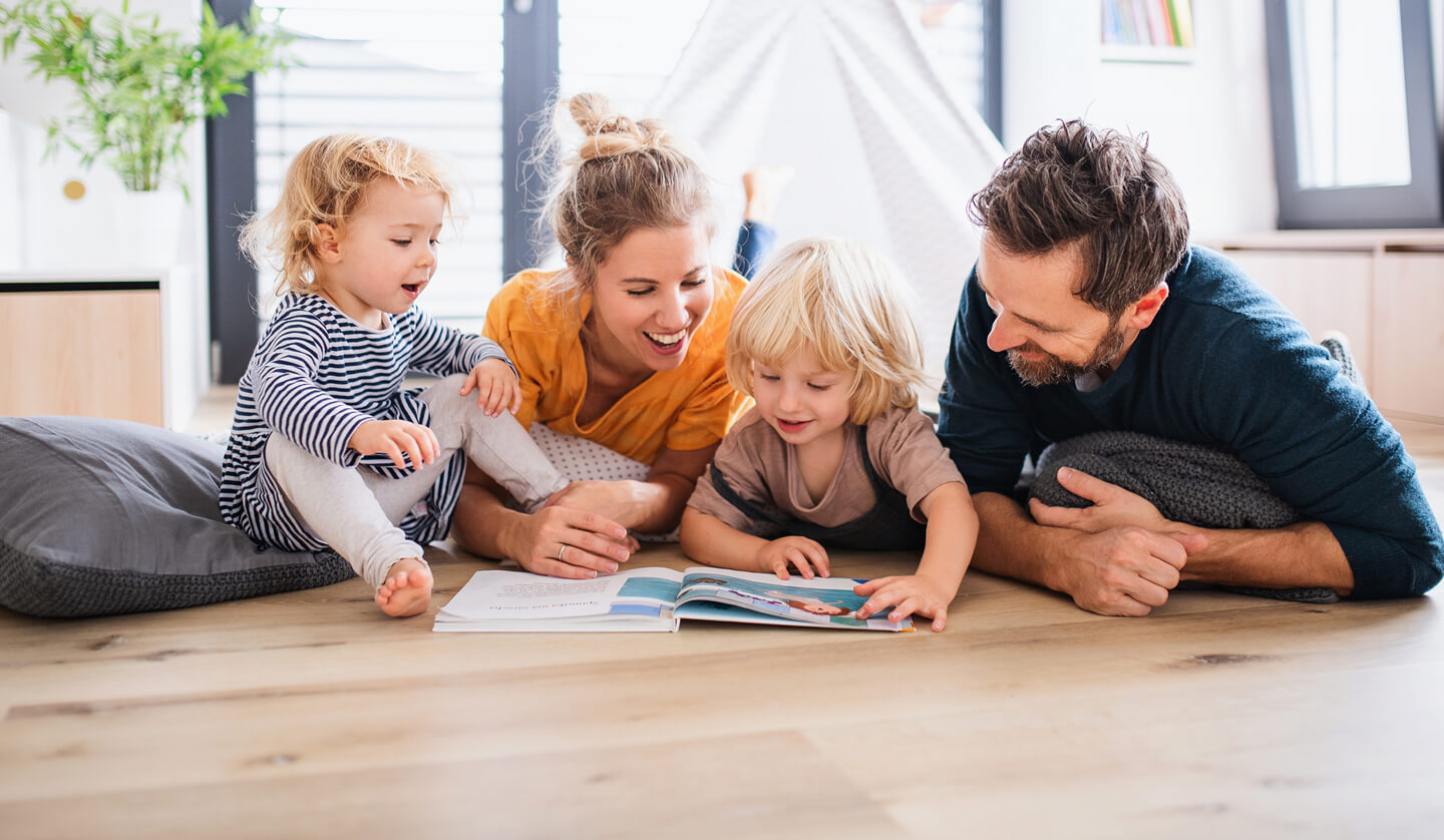 family of 4 reading books together