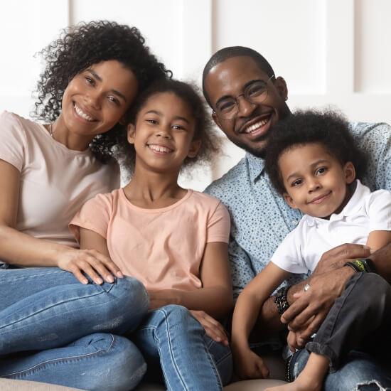 family of 4 sitting on couch