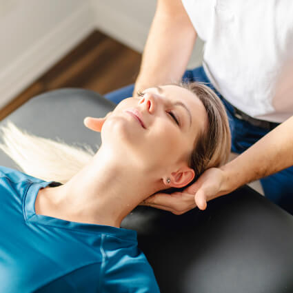 woman having neck adjusted