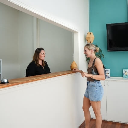 Female patient laughing with receptionist
