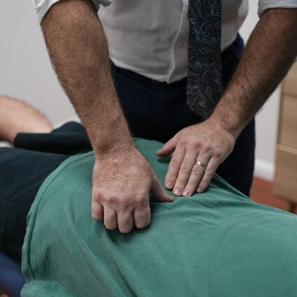 Patient with green shirt getting adjusted
