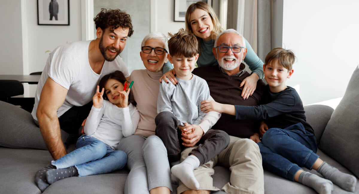 Smiling family sitting on a couch