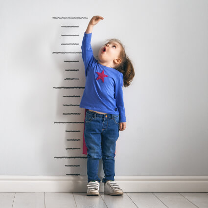 Little girl checking her height