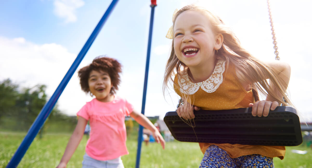 Girls playing on a swing