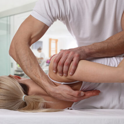 Chiropractor adjusting patient's back