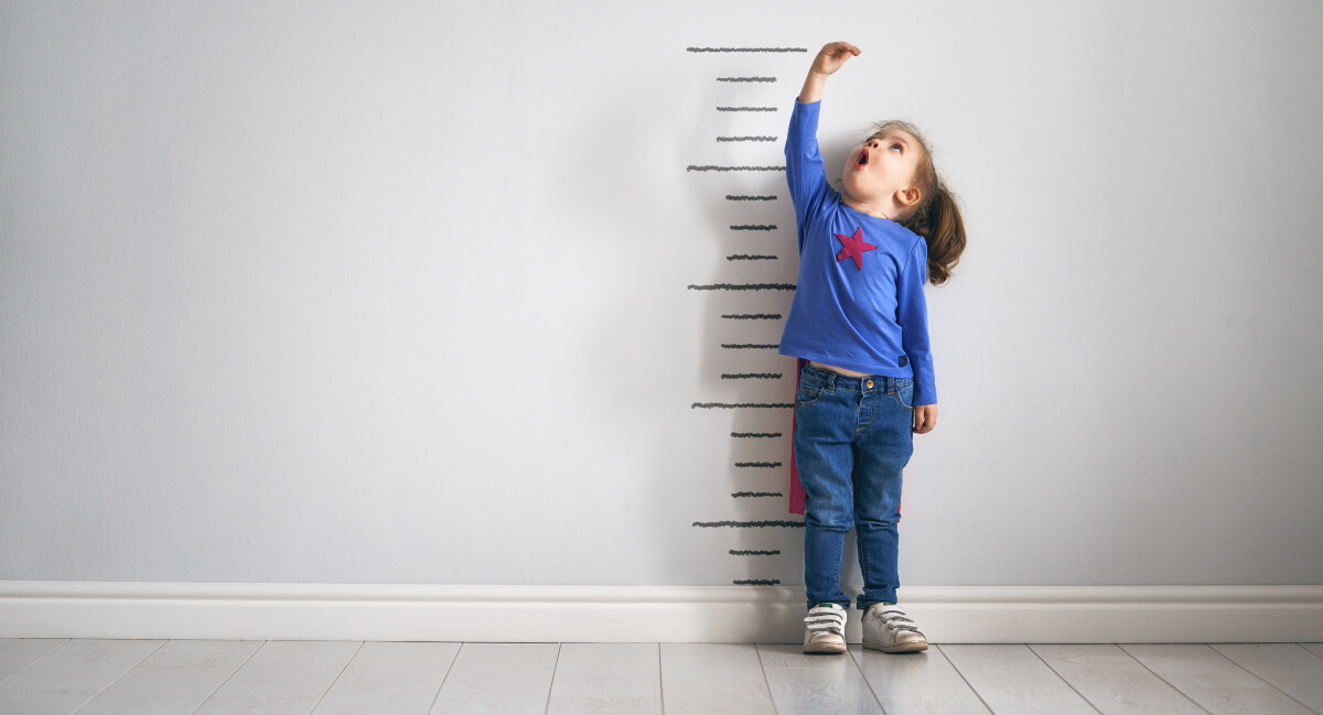 Little girl checking her height