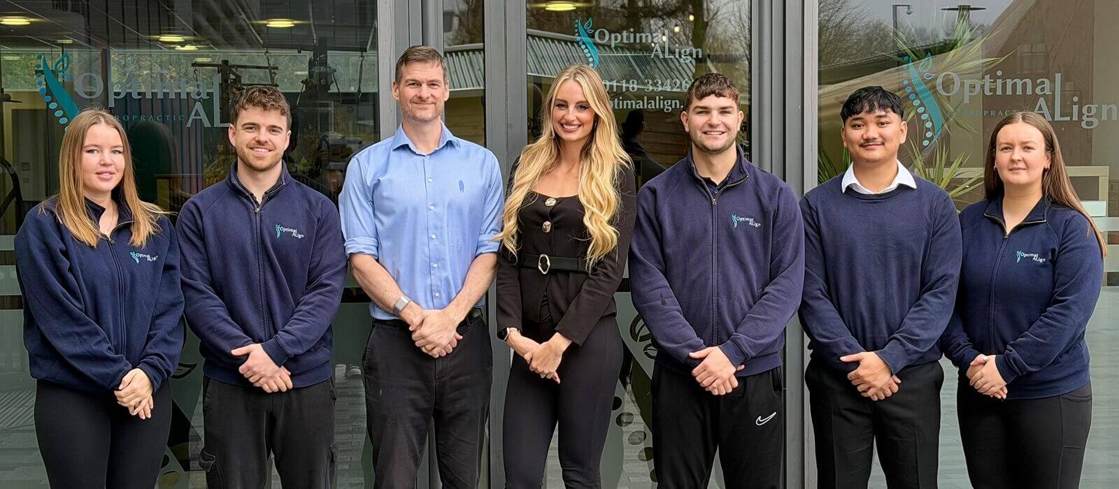 Mom, dad, and young girl posing for a photo