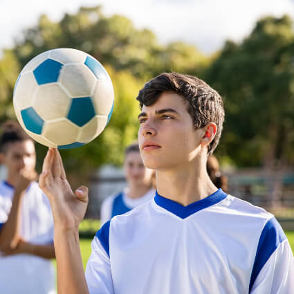 Young man playing with soccer ball