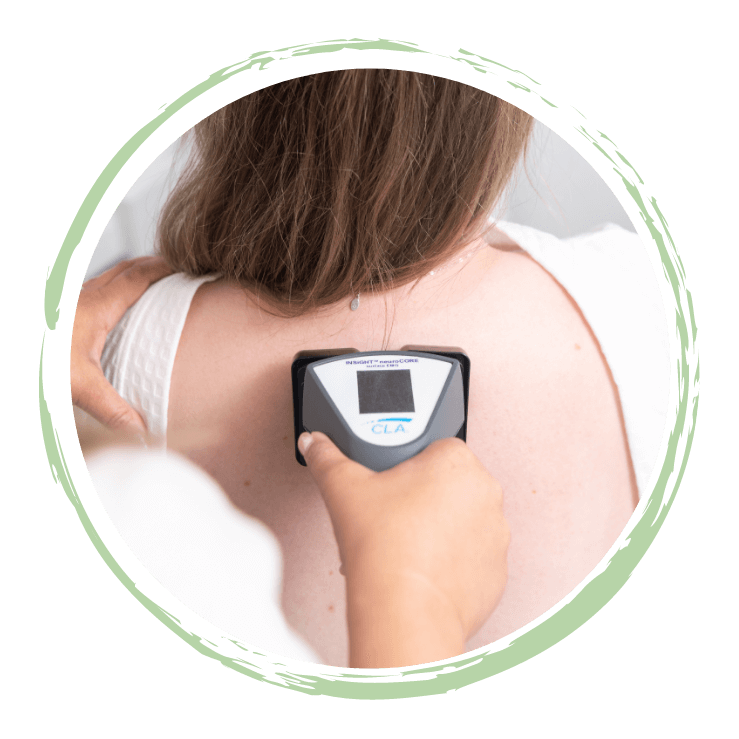 Chiropractor using scanning device on South Surrey patient