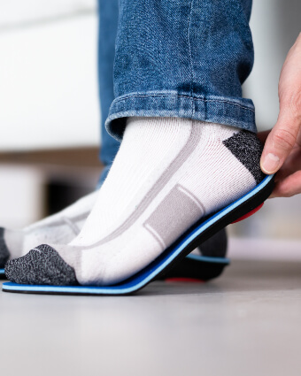 Man fitting orthotics