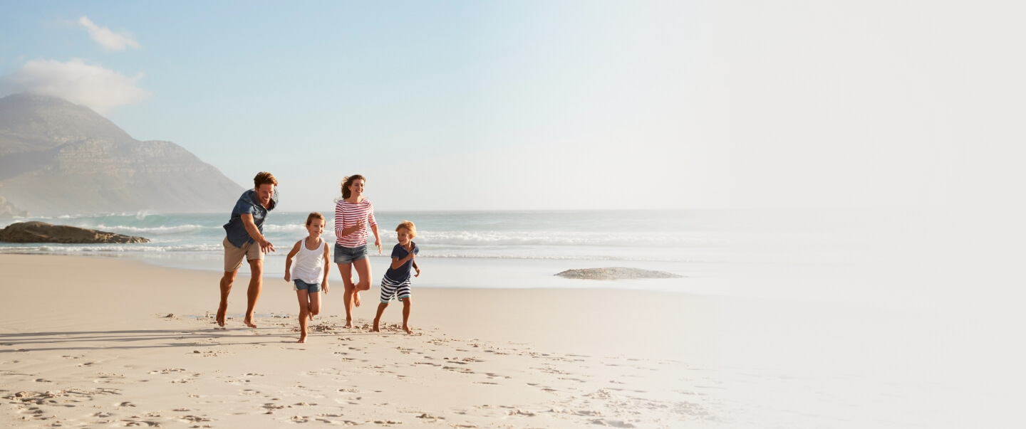 family running on the beach