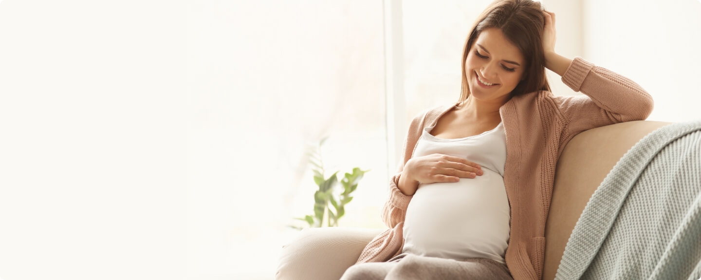 pregnant woman sitting on the couch