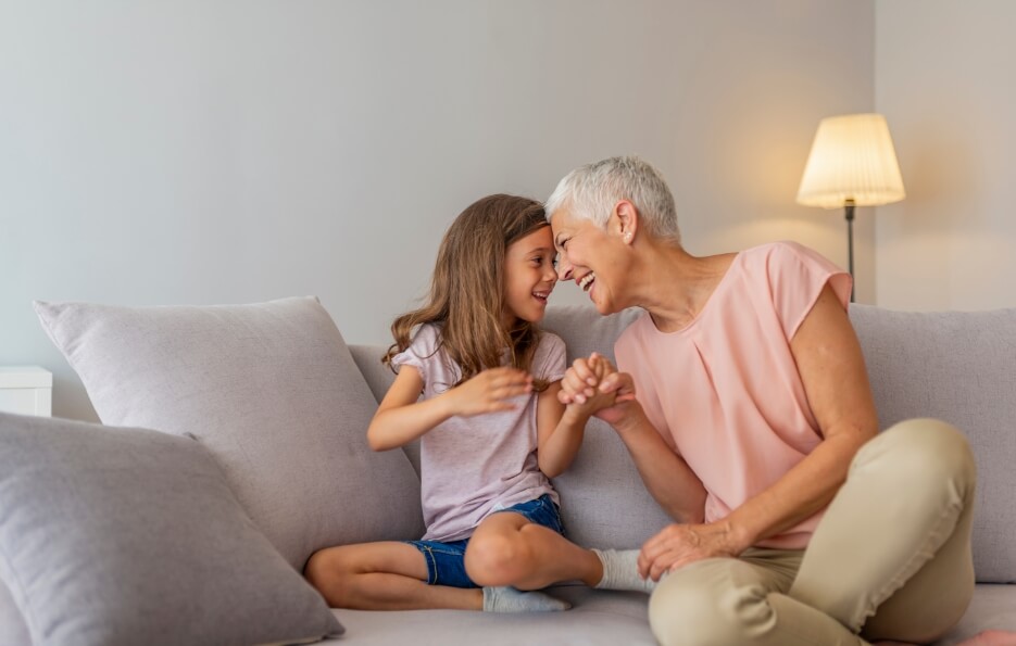 grandmother and granddaughter laughing
