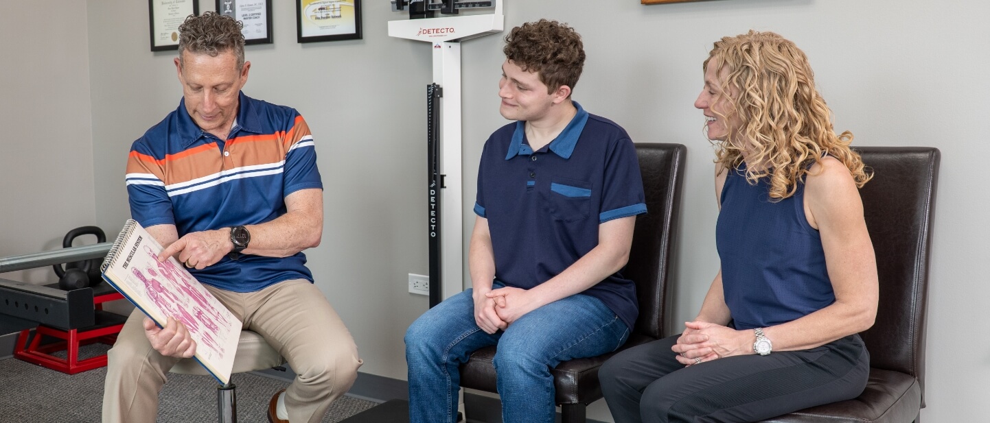 Denver chiropractor Dr. Glenn talking with patients