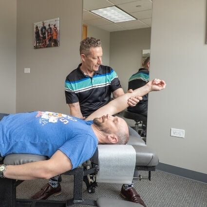 Dr Glenn adjusting patients arm
