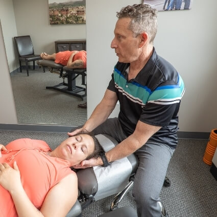 Dr Glenn adjusting patients neck