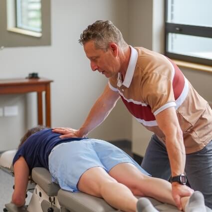 Dr Glenn adjusting patients leg
