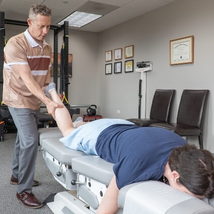 Dr Glenn adjusting patients leg