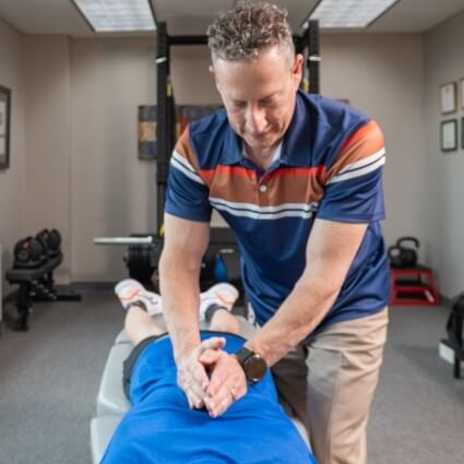 Dr Glenn adjusting patients lower back