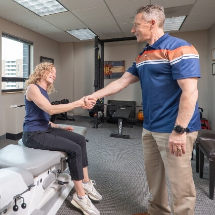 Dr Glenn shaking patients hand