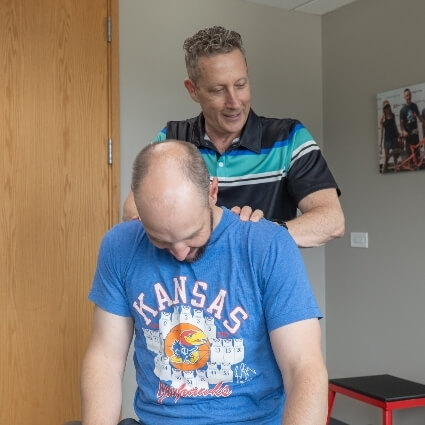 Dr Glenn adjusting patients neck